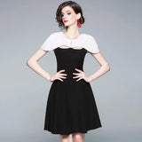 autumn new European and American commuter black and white color cloak dress