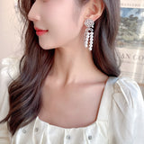2025 Light luxury, high-end sense, excellent temperament, wedding banquet, bridal earrings, trendy long hollow camellia pearl fringed earrings